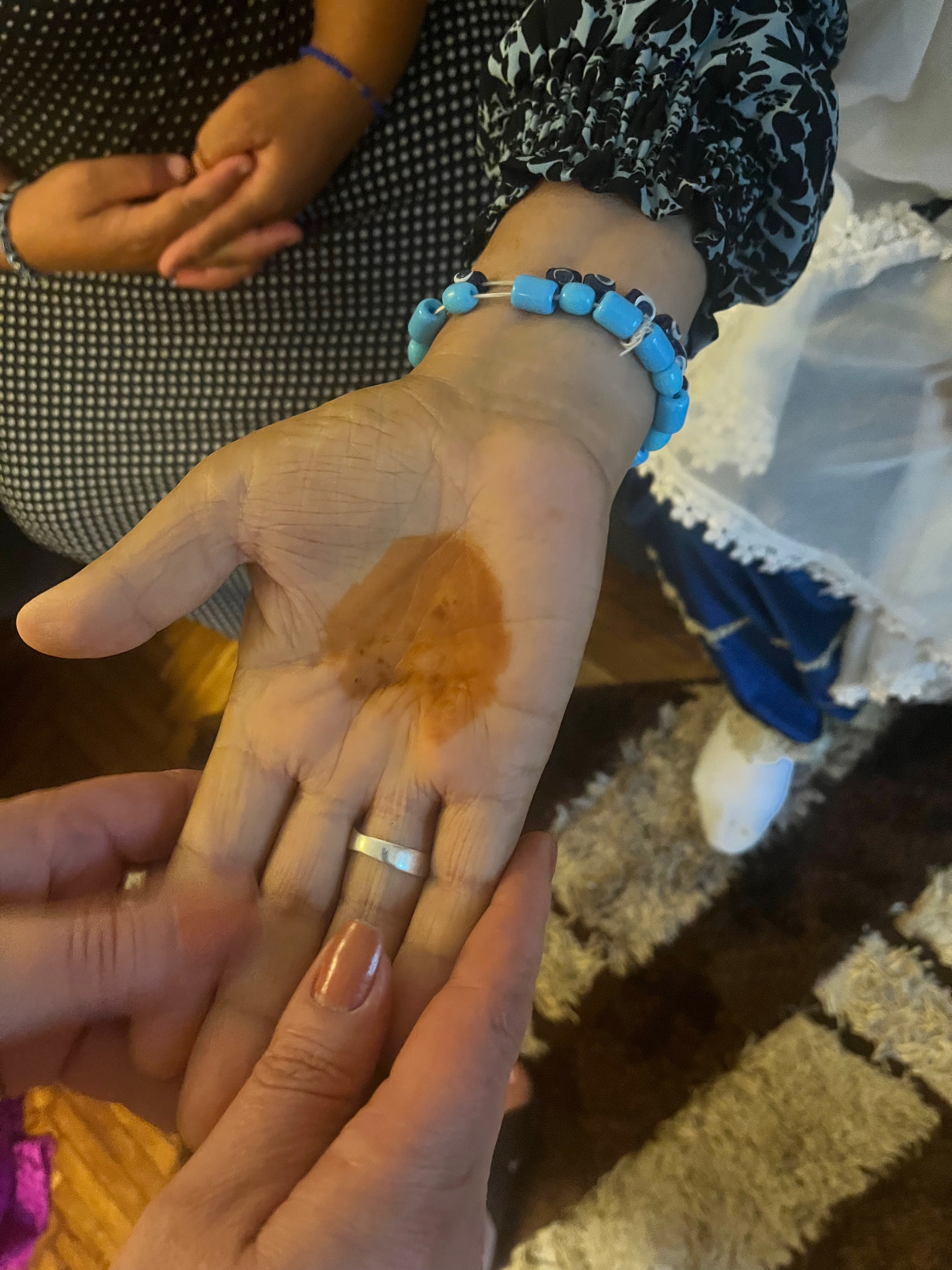 Woman from the Turkish Tinsmiths community, henna-painted hand and wearing a bracelet with Nazar Boncuğu (evil eye), Tulcea, Tulcea County, July 2023